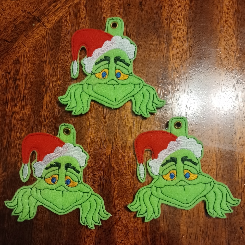 Set of three Grinch Christmas candy cane holders